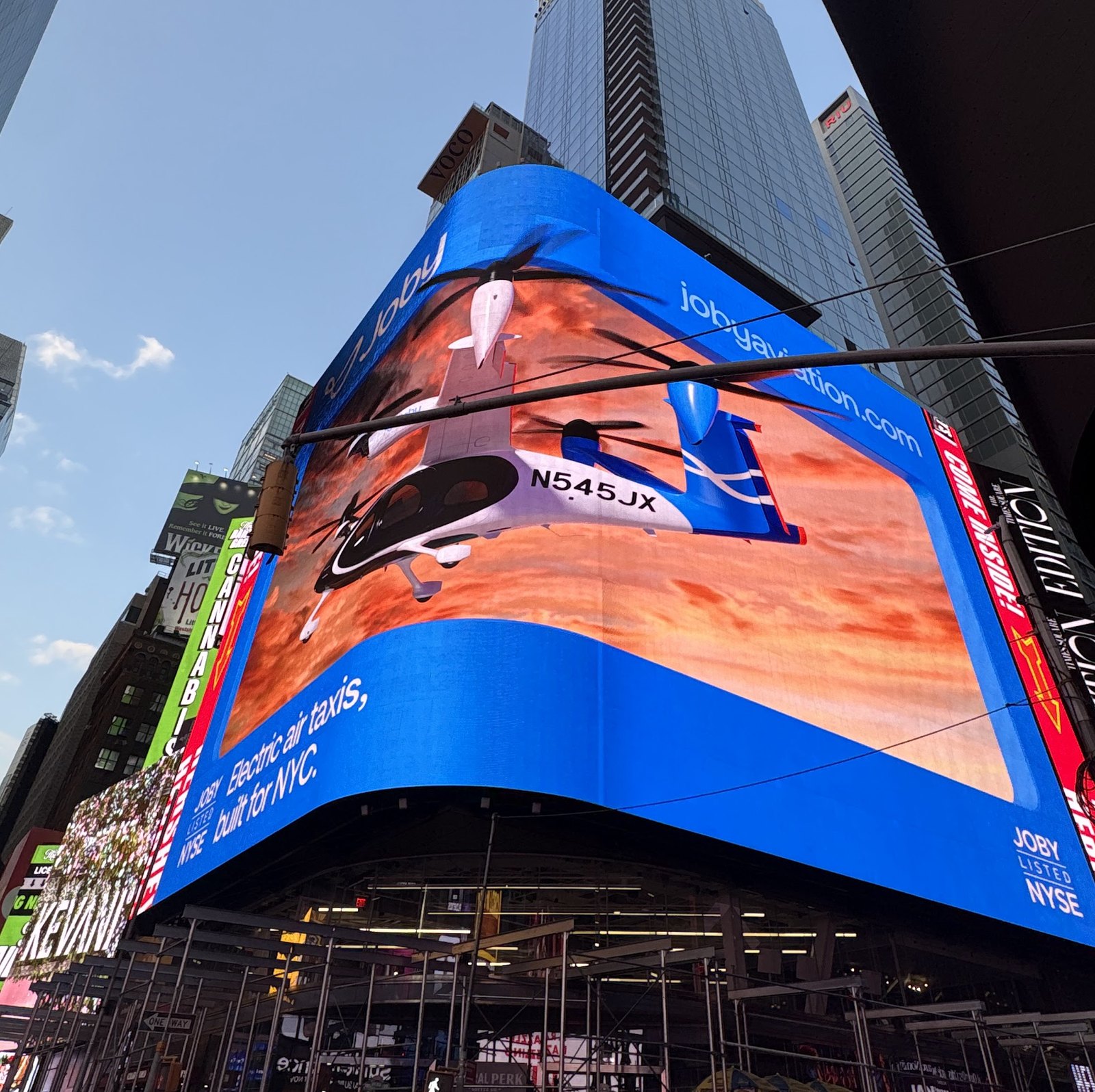 Looking up at the Joby billboard on the corner of Times Square, the S4 leaving the screen